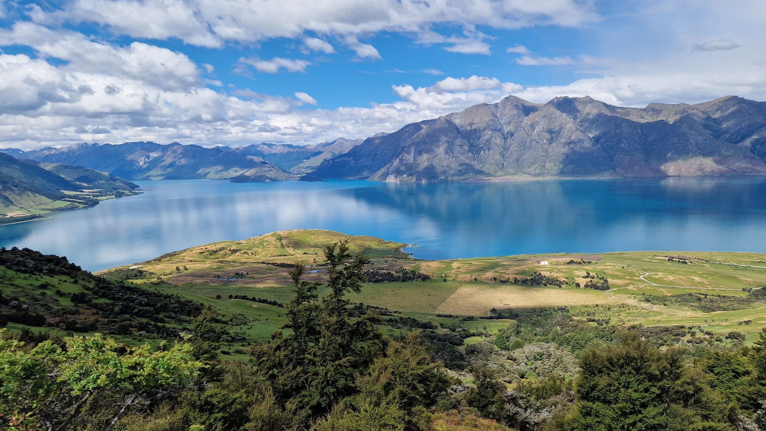 An elevated view of a lake and mountains in the distance